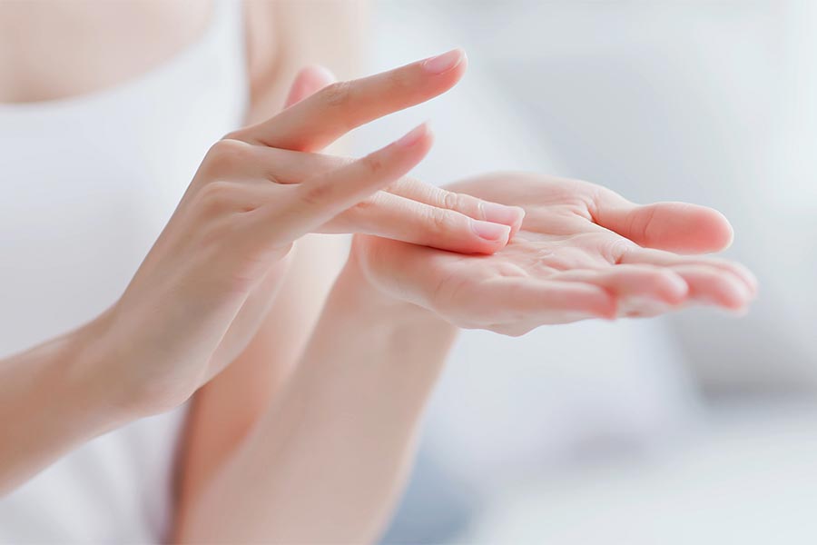 Woman apply moisturizer in hand